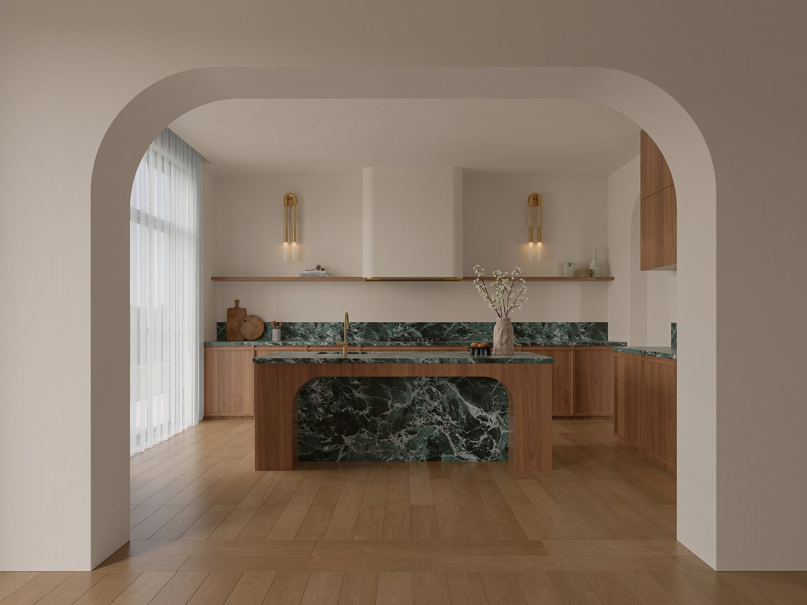 Kitchen seen through an arch, with a deep green marble-look island and splashback